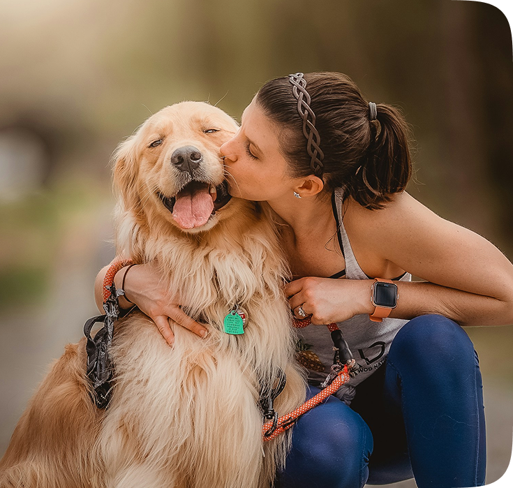 A woman kissing a golden retriever, showing affection and connection. A woman kissing a golden retriever, showing affection and connection.